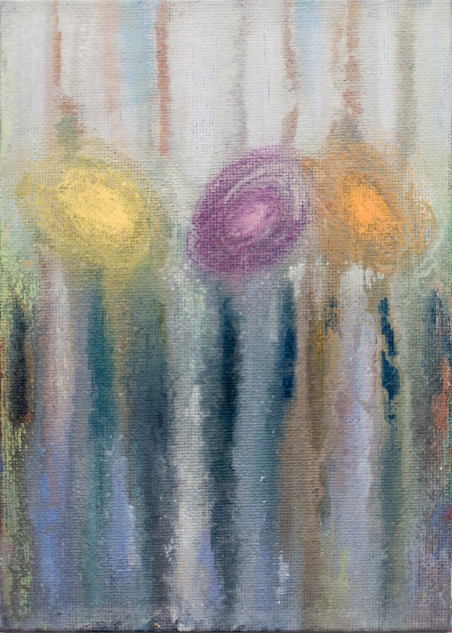 A small abstract painting (5x7 inches) created with water-soluble wax crayons on a gesso-primed canvas board. Soft vertical streaks of blue, grey, and muted green flow downward, blending seamlessly. Three circular forms—yellow, violet, and orange—hover in the upper half, their edges diffused, as though dissolving into the background. The layering of colour and subtle textures create an ethereal, atmospheric quality.